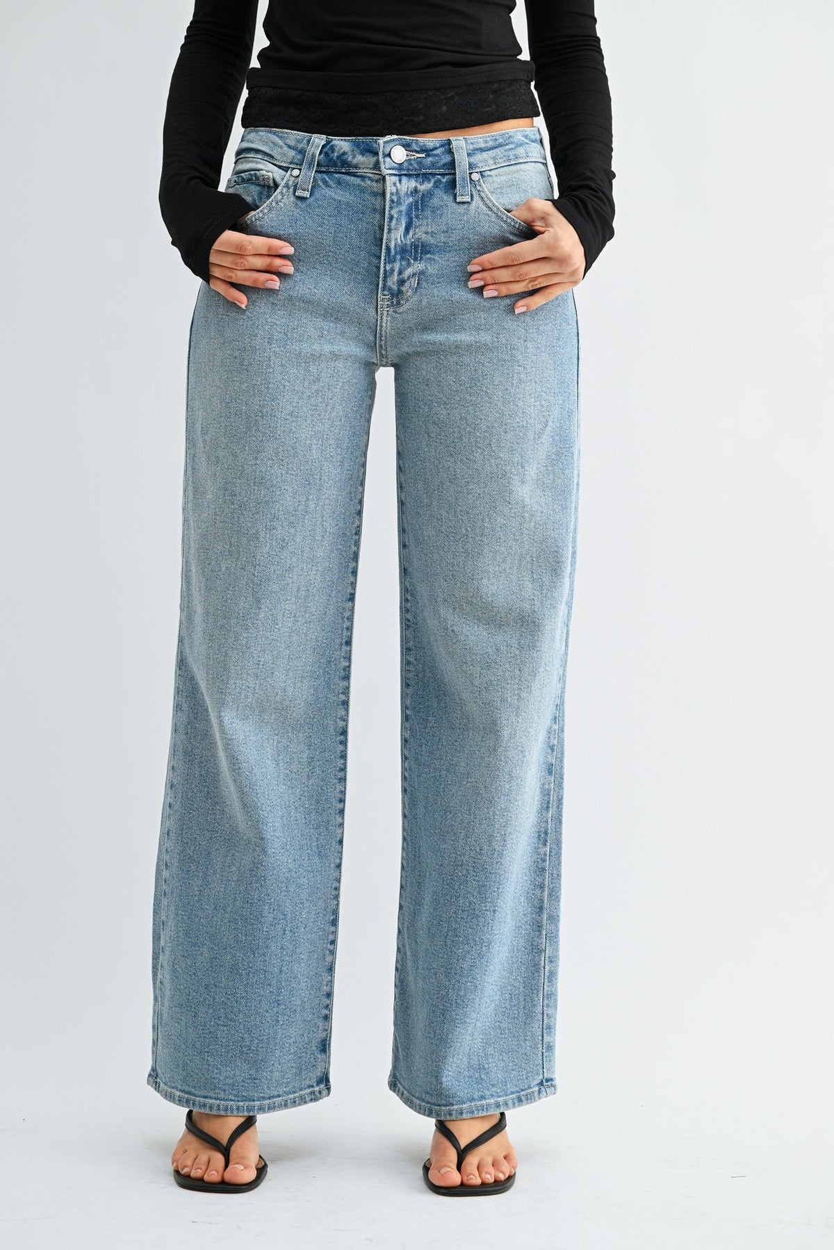 Woman modeling light wash straight leg denim jeans