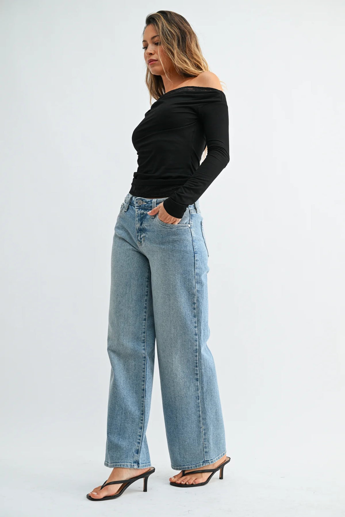 Woman modeling light wash straight leg denim jeans