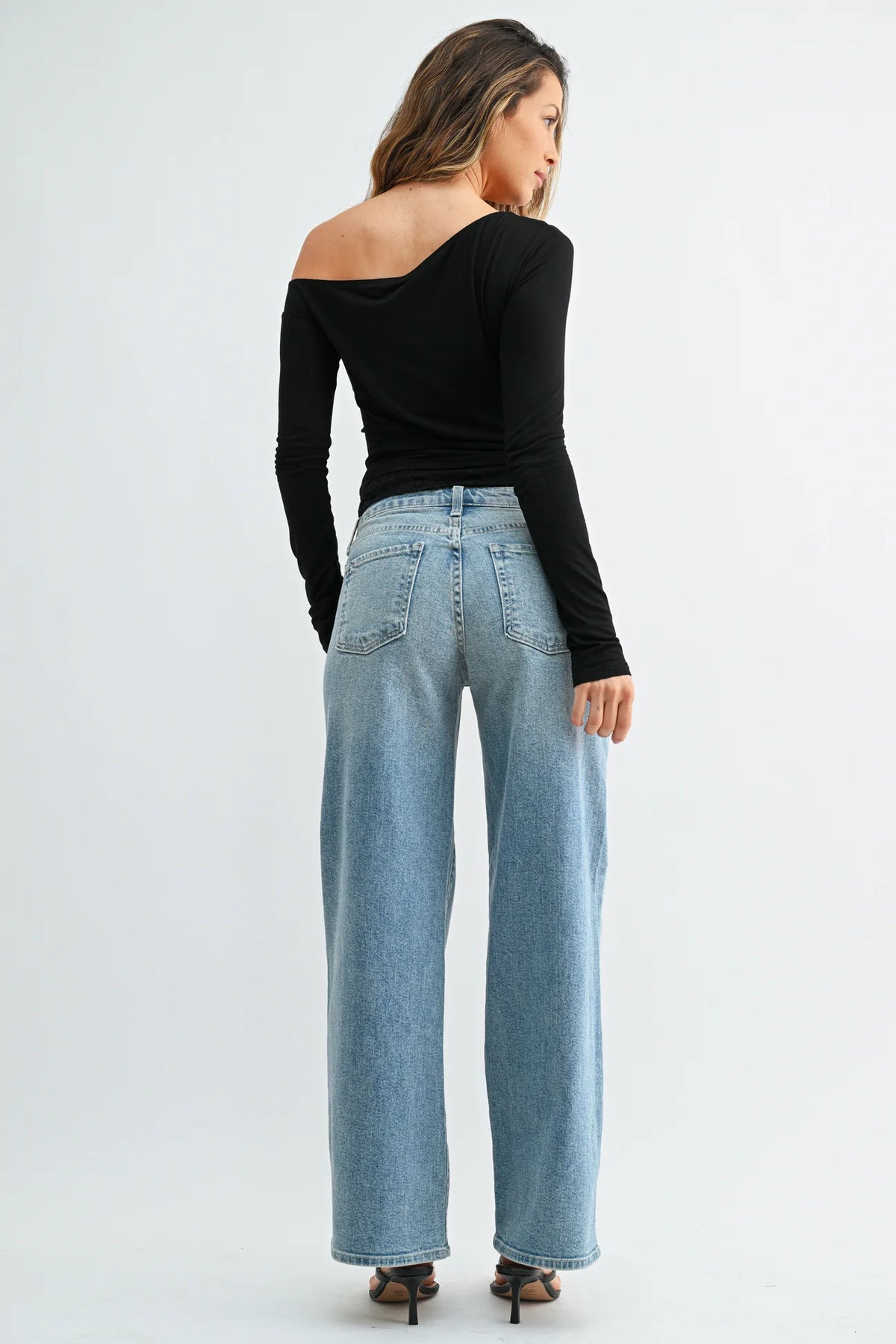 Woman modeling light wash straight leg denim jeans