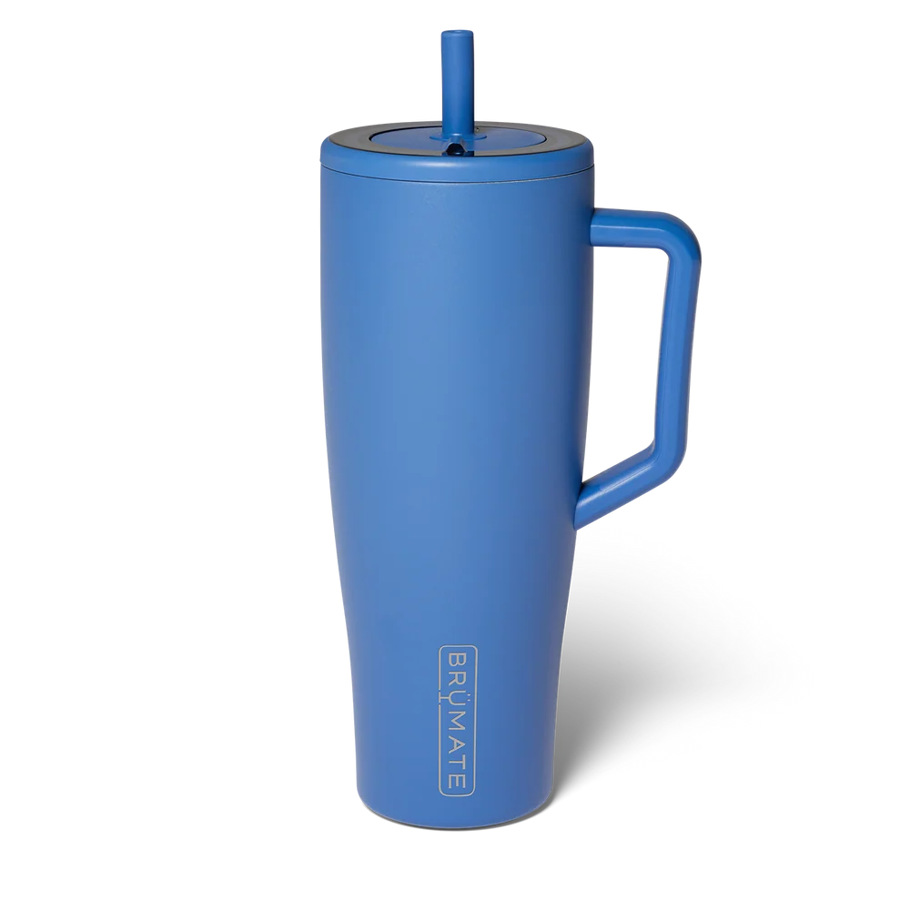 A matte blue insulated travel tumbler with a matching blue lid, handle, and straw, shown on a clean white background. The brand name 'BRUMATE' is printed vertically near the bottom.