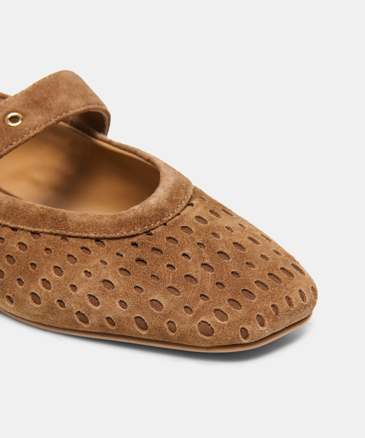 Brown suede Mary Jane flats featuring perforated detailing and an adjustable gold-tone buckle strap.