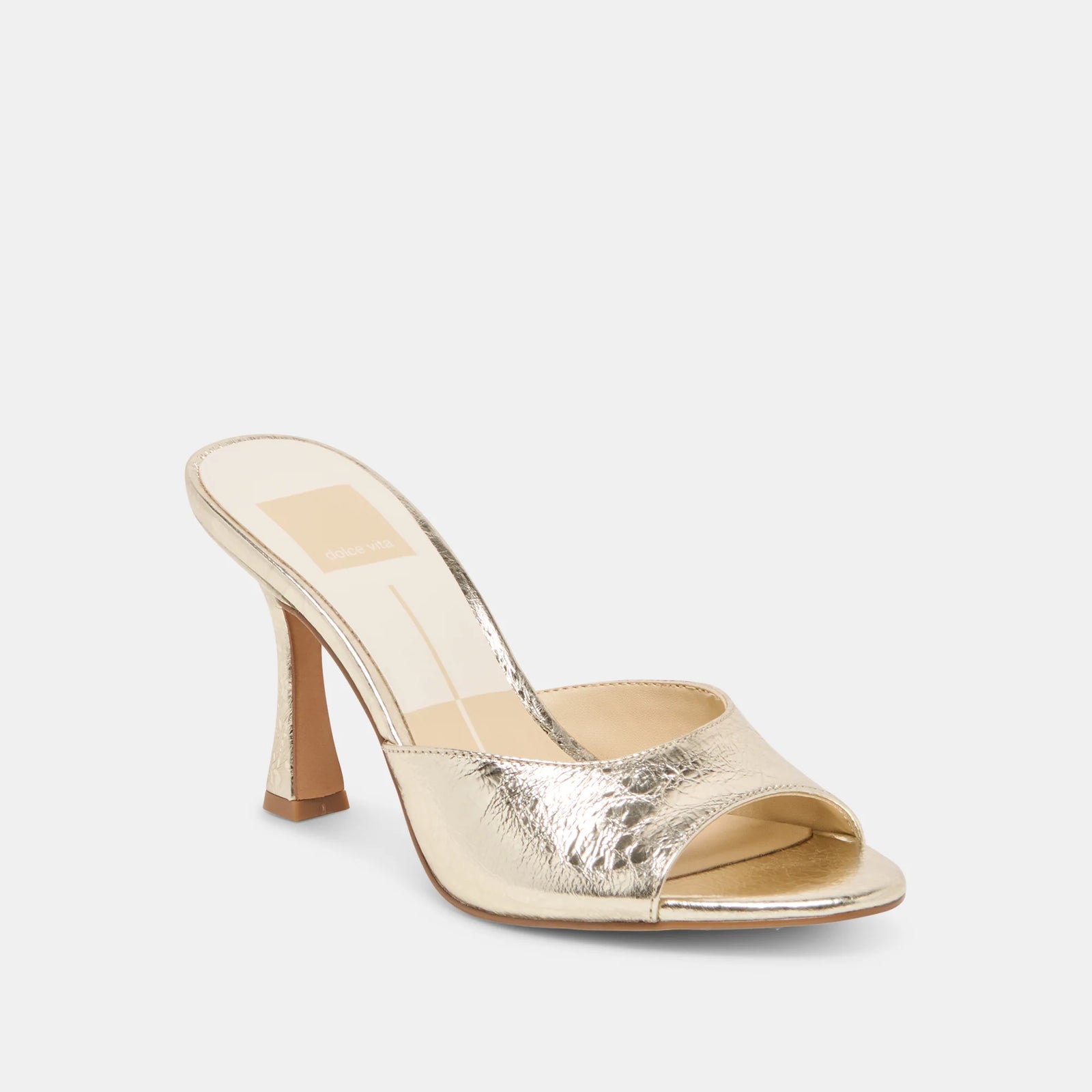 Gold high-heeled shoe on a white background