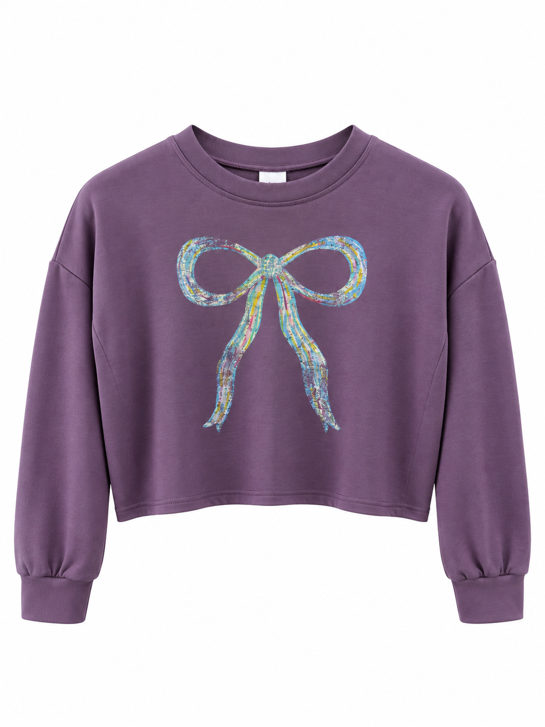 A purple cropped sweatshirt with a large bow graphic on the front, featuring a multicolor patterned design with shades of blue, yellow, and green.
