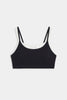 A black camisole-style bralette with thin double shoulder straps and a white inner neckline, displayed flat against a light gray background.