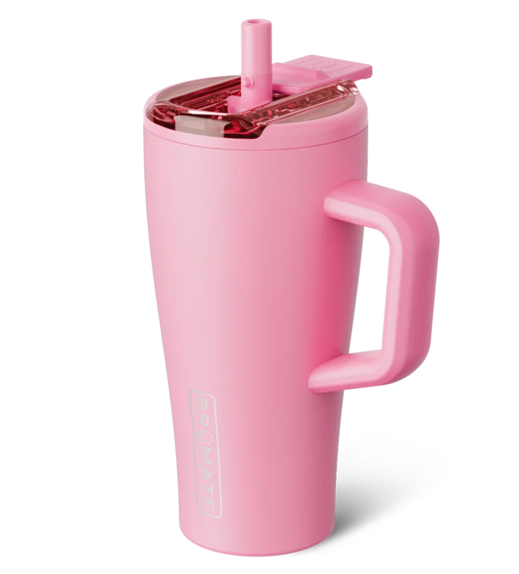 A pink vacuum-insulated travel tumbler with a matching pink handle and lid, featuring a clear lid and straw, on a solid white background.