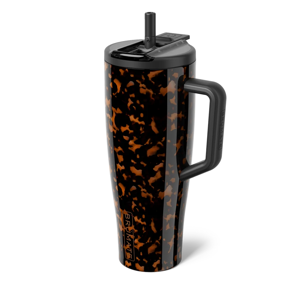 A tall handled tumbler with a black and amber tortoiseshell pattern, featuring a black lid with a straw and a black handle, shown on a white background.