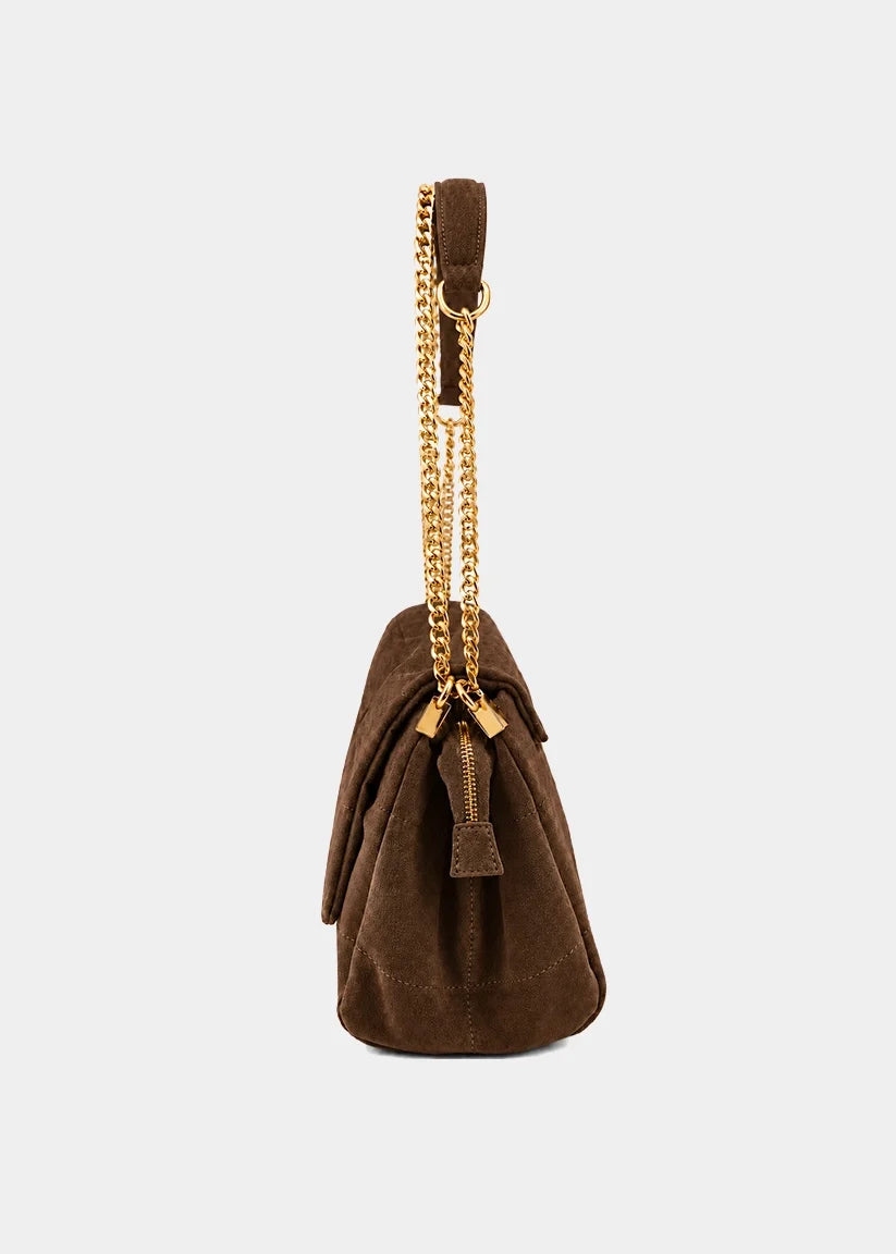 Side view of a brown suede shoulder bag with gold chain strap and front flap pocket.