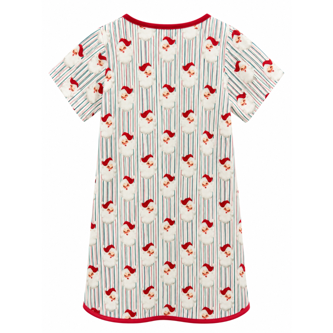 A short-sleeve baby tunic nightshirt featuring an all-over print of Santa Claus faces and hats on vertical stripes, finished with red trim on the neckline, sleeve cuffs, and hem.