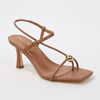 Brown sandal with thin straps on a white background