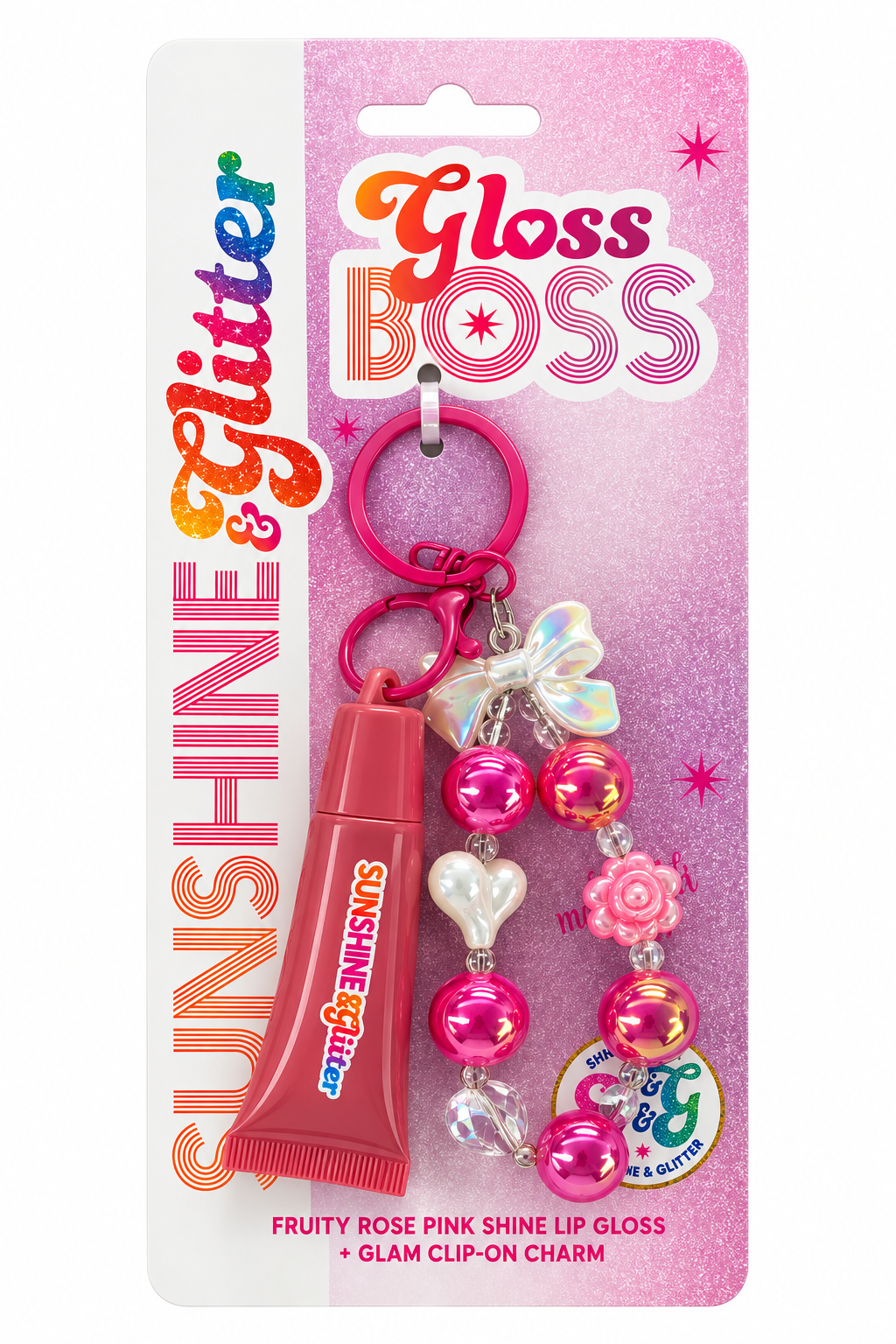 Sunshine & Glitter Gloss Boss lip gloss and glam clip-on charm set in pink packaging. The set includes a pink tube of lip gloss and a matching pink beaded charm with a butterfly, heart, and flower.