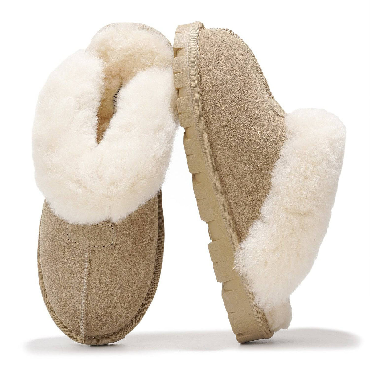 A pair of beige suede slip-on slippers with thick white shearling-style lining, shown on a clean white background.