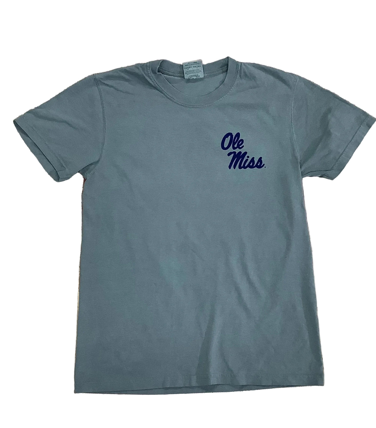A slate gray short-sleeve t-shirt with 'Ole Miss' printed in navy blue script on the left chest, laid flat on a rustic wooden plank background.
