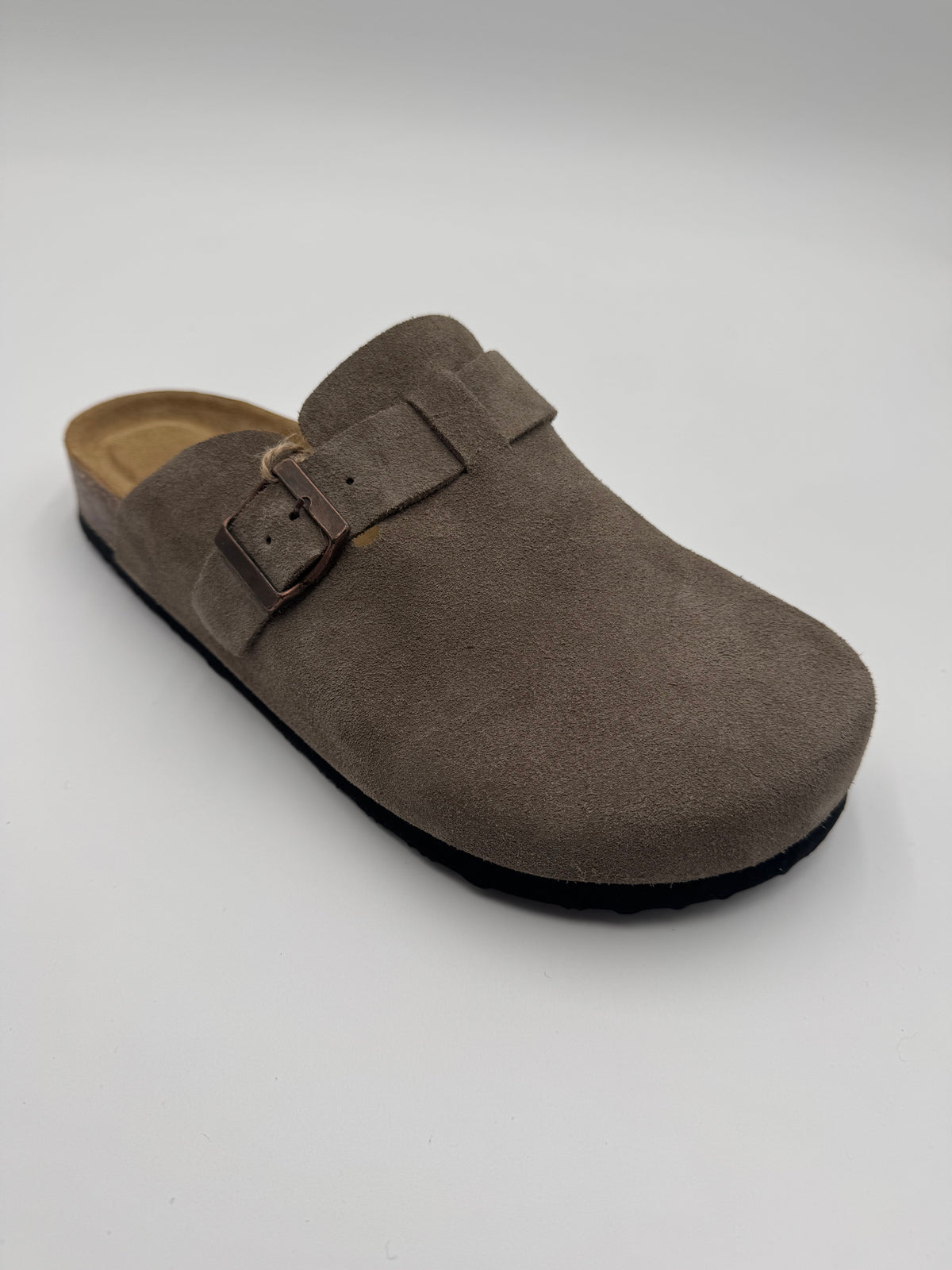 A single taupe-brown suede clog shoe with a double-buckle strap and a black outsole, photographed on a light gray background.