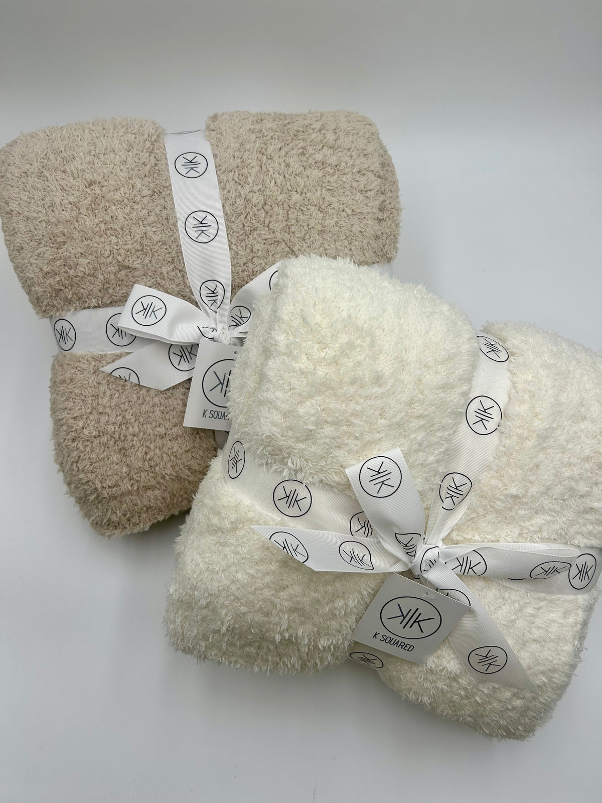 stone and cream throw blanket on white backdrop