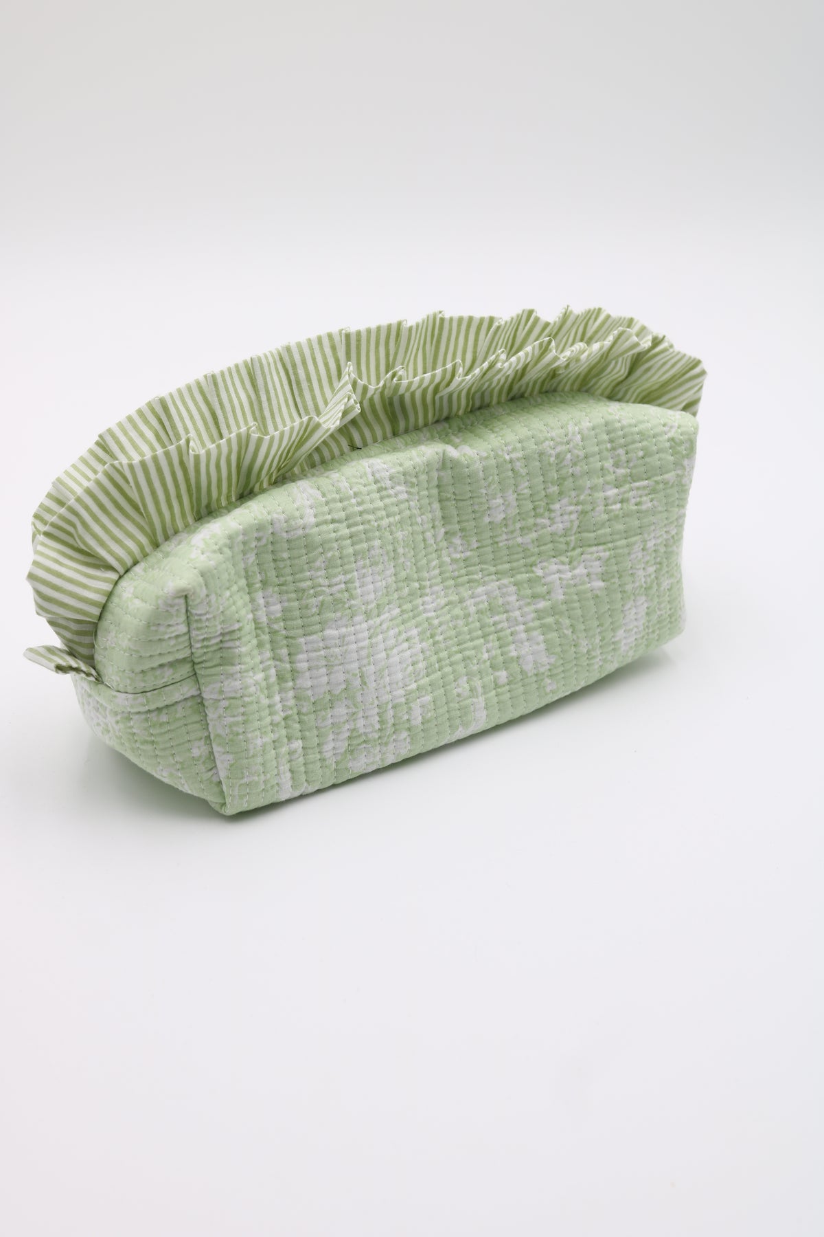 A light green and white patterned fabric pouch with a pleated ruffled top, photographed on a clean white background.