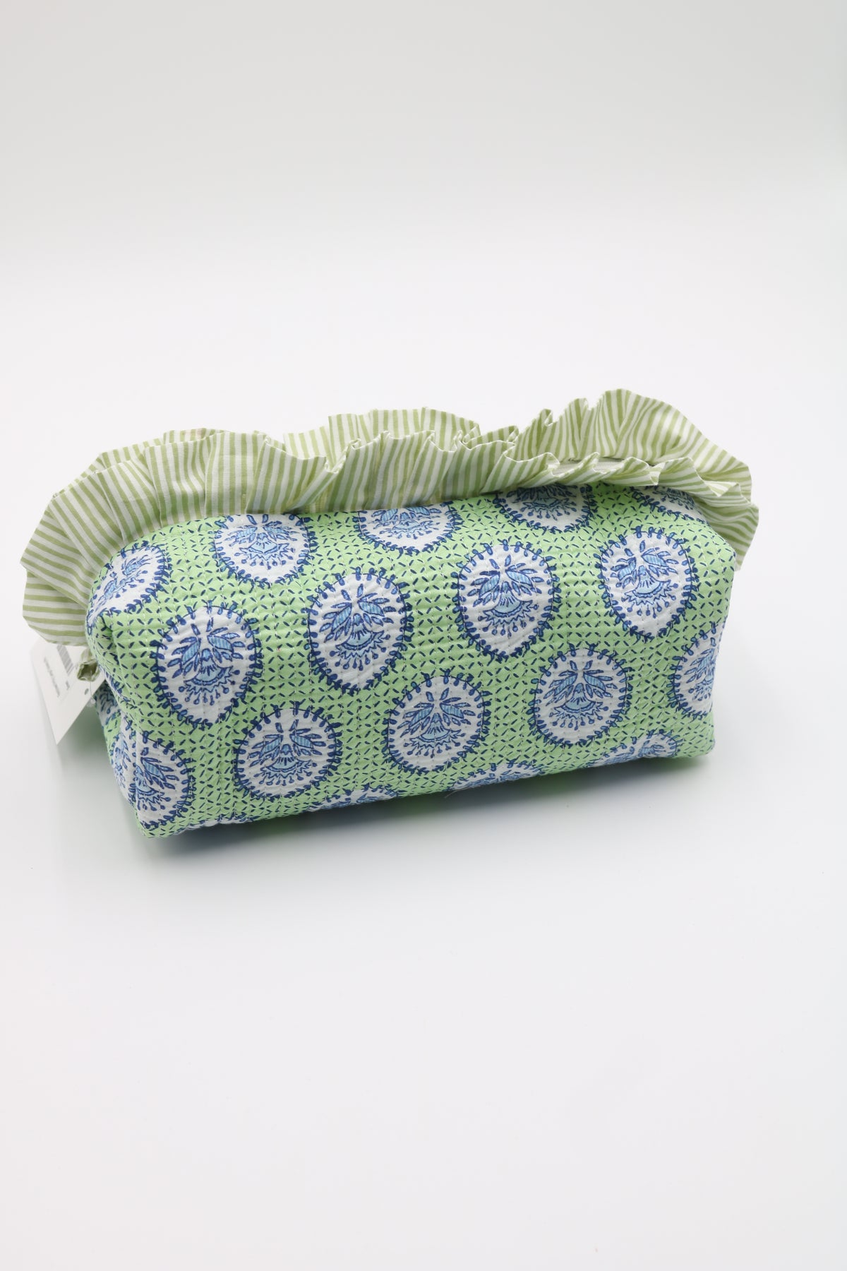 A fabric cosmetic pouch with a green and white striped ruffled top, featuring a green body printed with blue and white circular medallion patterns, on a white background.