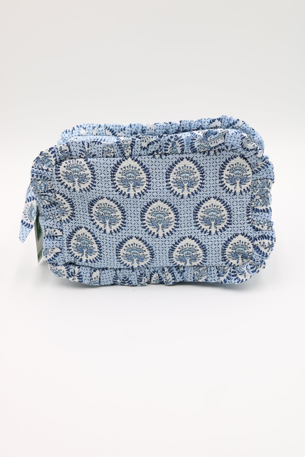 A small rectangular pouch or clutch with a ruffled edge, covered in a blue and white woven floral pattern, photographed on a plain light background.
