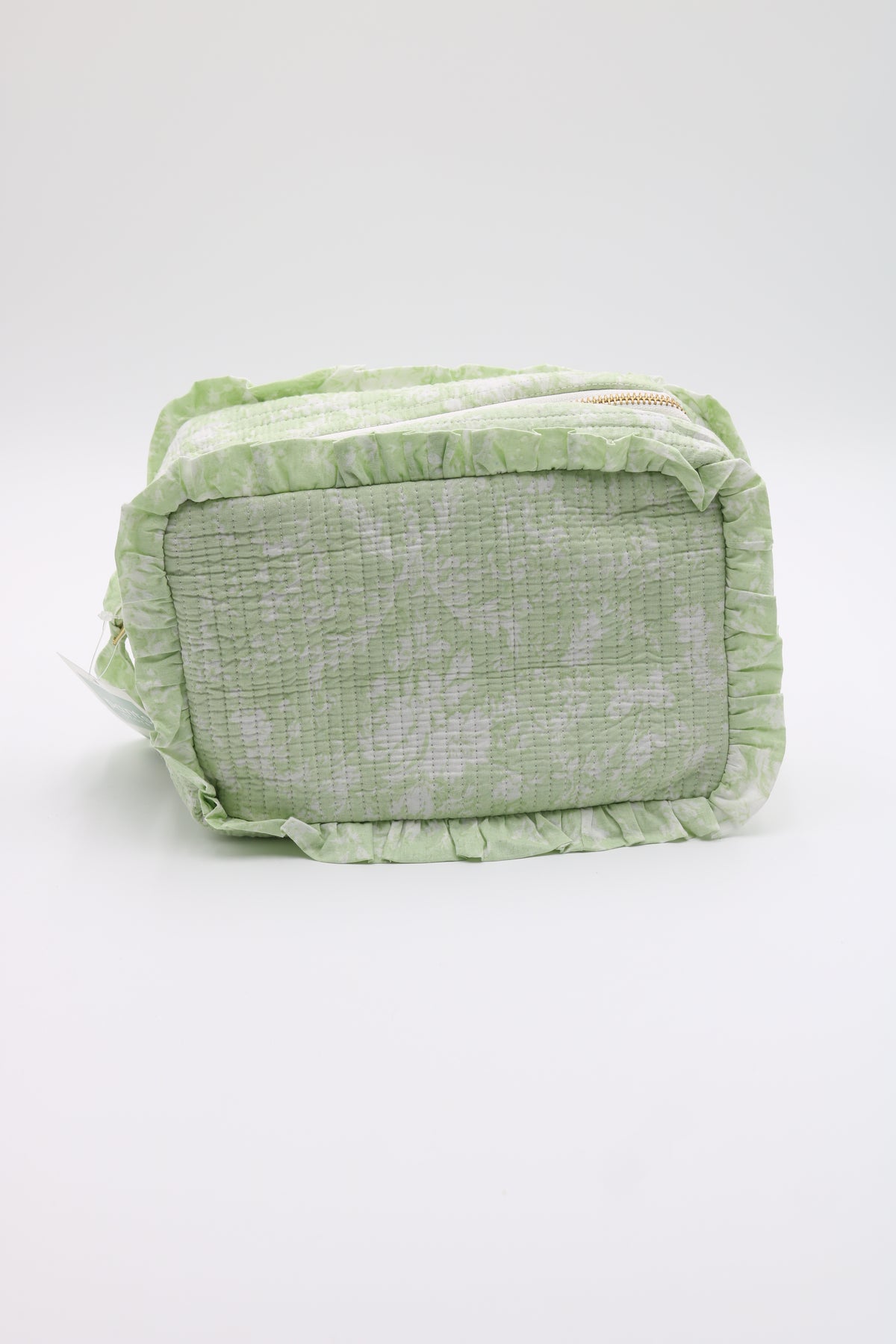 A light green and white patterned fabric pouch with ruffled trim, photographed on a clean white background.