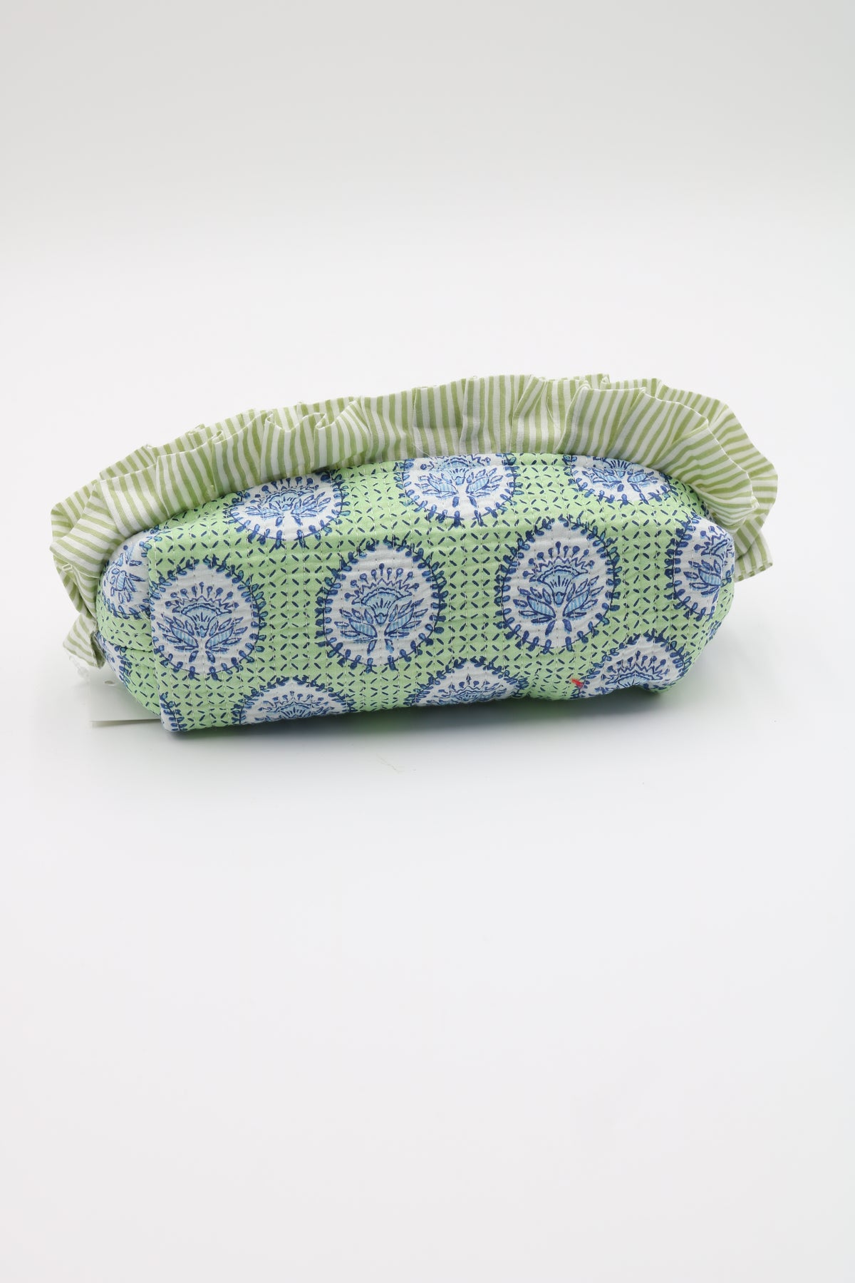 A small fabric pouch or cosmetic bag with a green and white striped ruffled trim and a light green body featuring a blue and white floral pattern, shown on a plain light gray background.