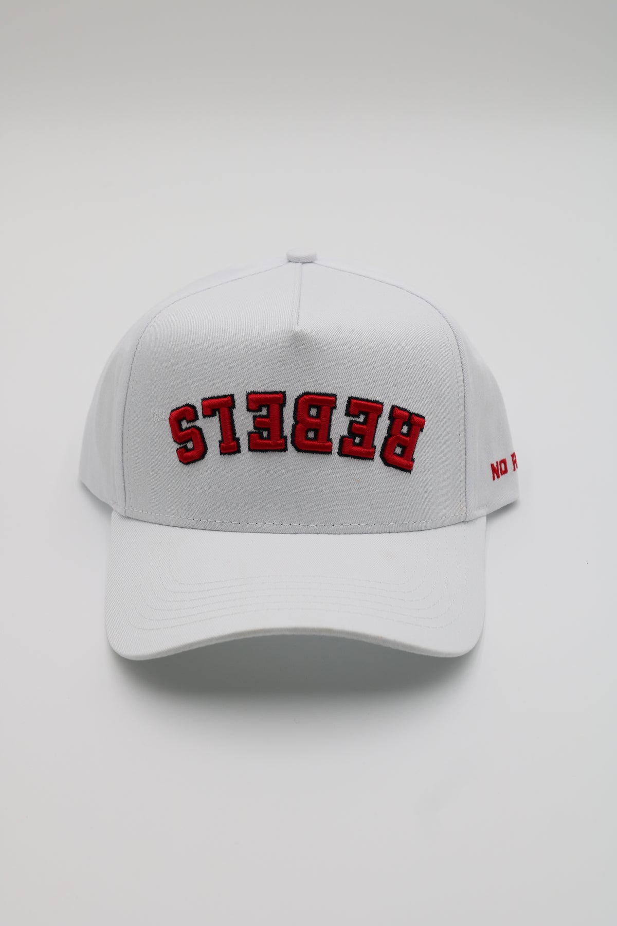 A white baseball cap with 'REBEKS' embroidered in red arched letters on the front, shown against a light gray background.