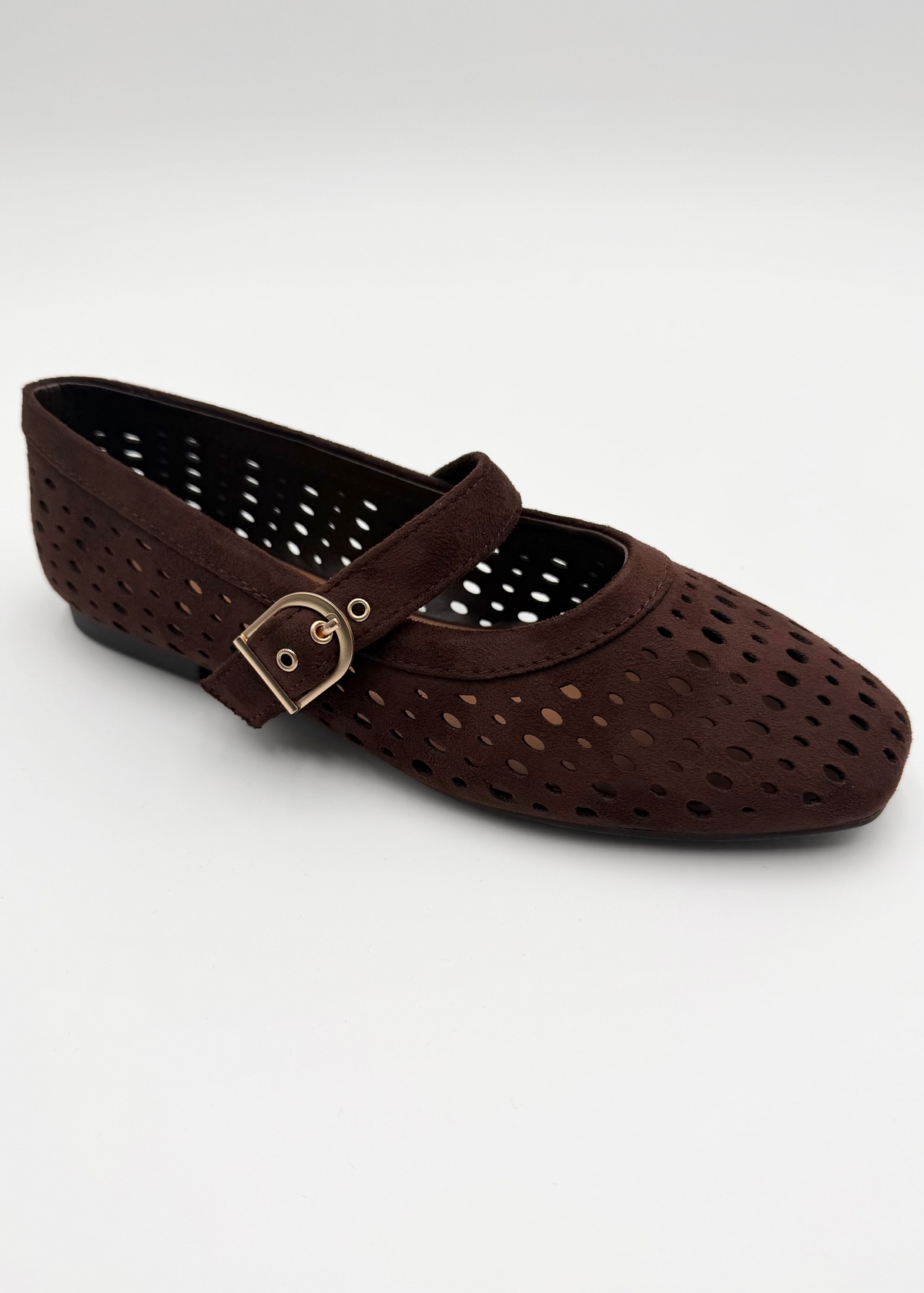 A dark brown perforated flat shoe with a strap and a small gold-tone buckle, shown on a light gray background.