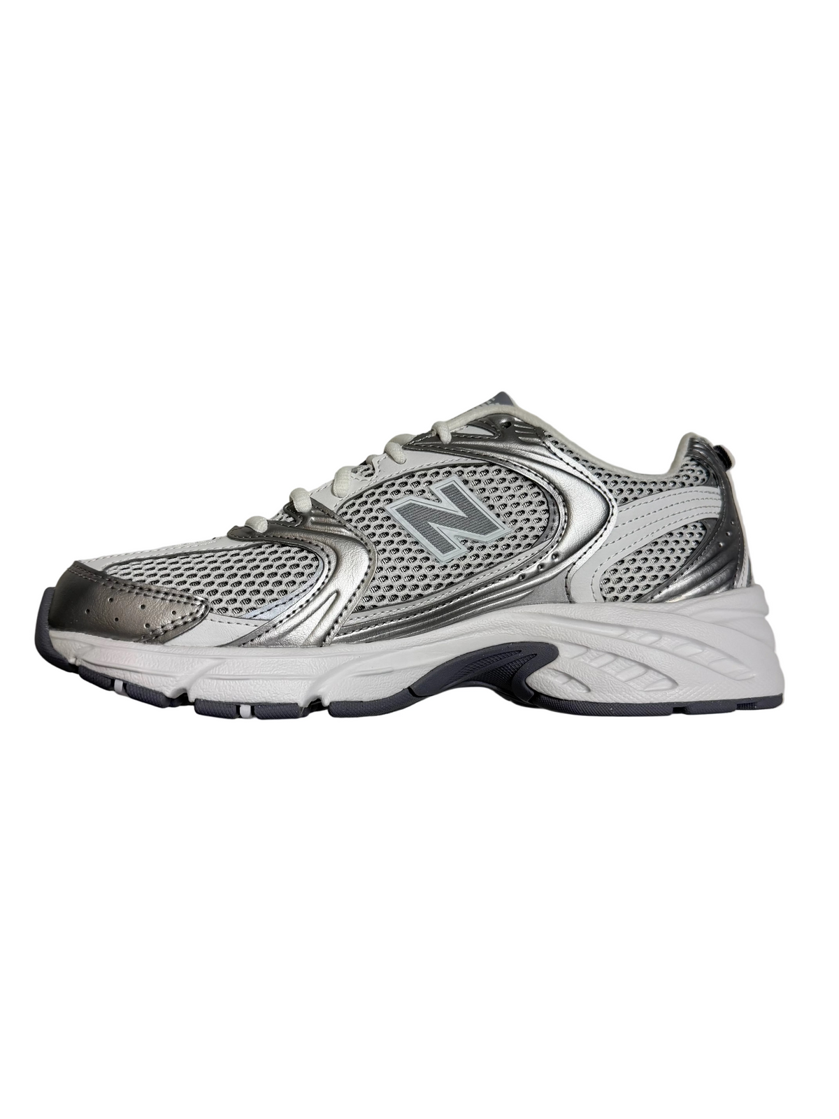 Silver and black athletic shoe on a light gray marble surface