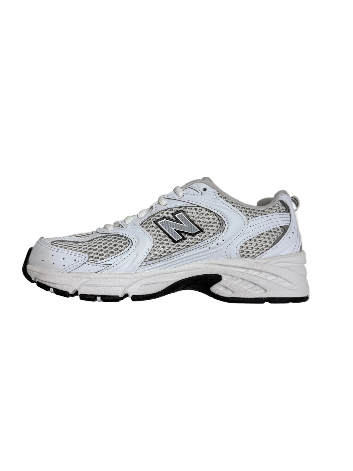 White running shoe with black sole on a light gray surface