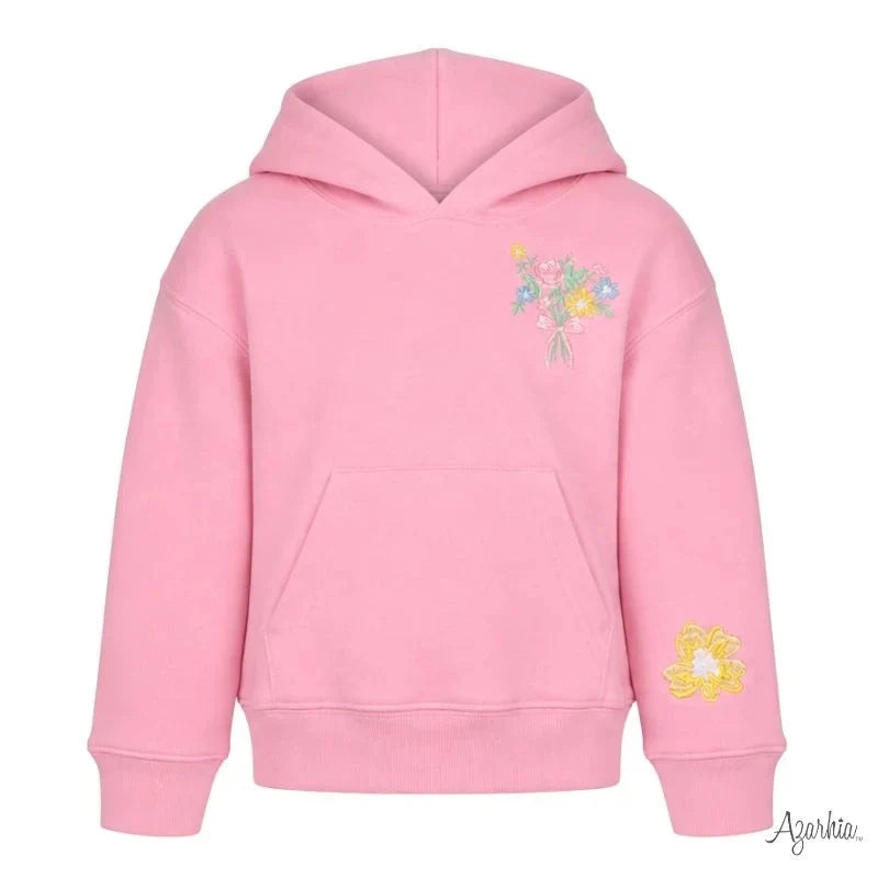 A pink pullover hoodie with a small multicolor floral embroidery on the left chest and a yellow flower embroidery on the right sleeve, shown against a plain white background.