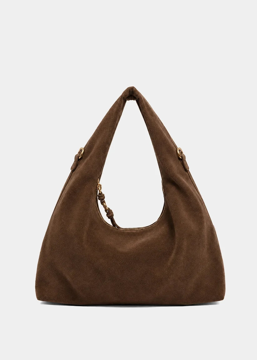 A brown suede hobo shoulder bag with a knotted leather handle detail and gold-tone hardware, shown against a plain light gray background.
