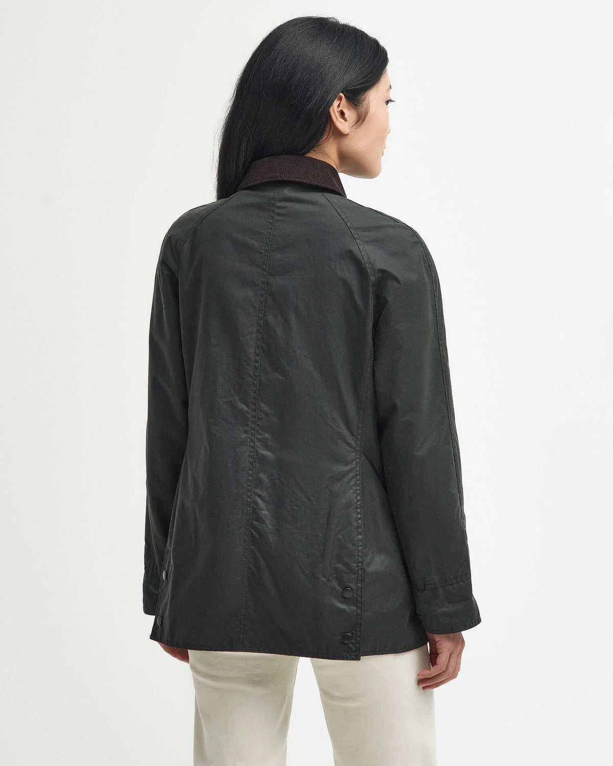 Person wearing a dark jacket on a light gray background