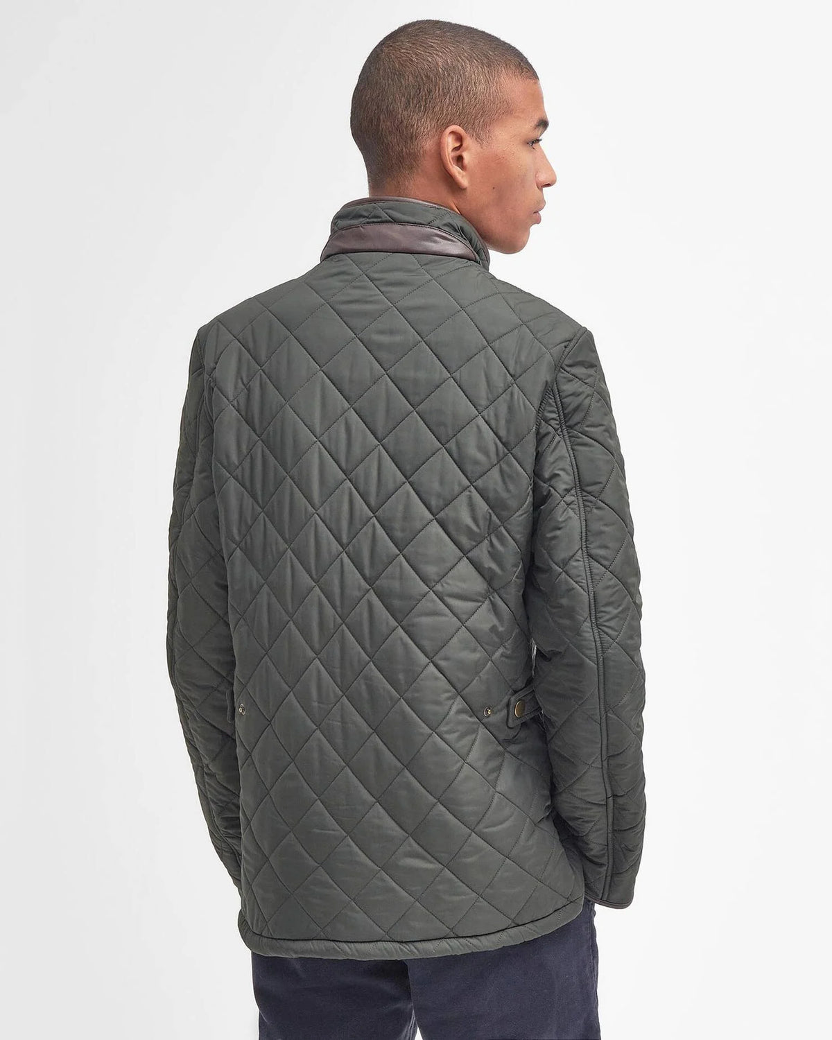 Man modeling dark colored quilted jacket