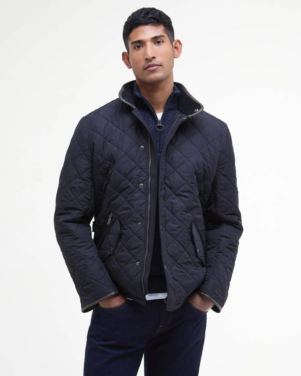 Man modeling dark colored quilted jacket