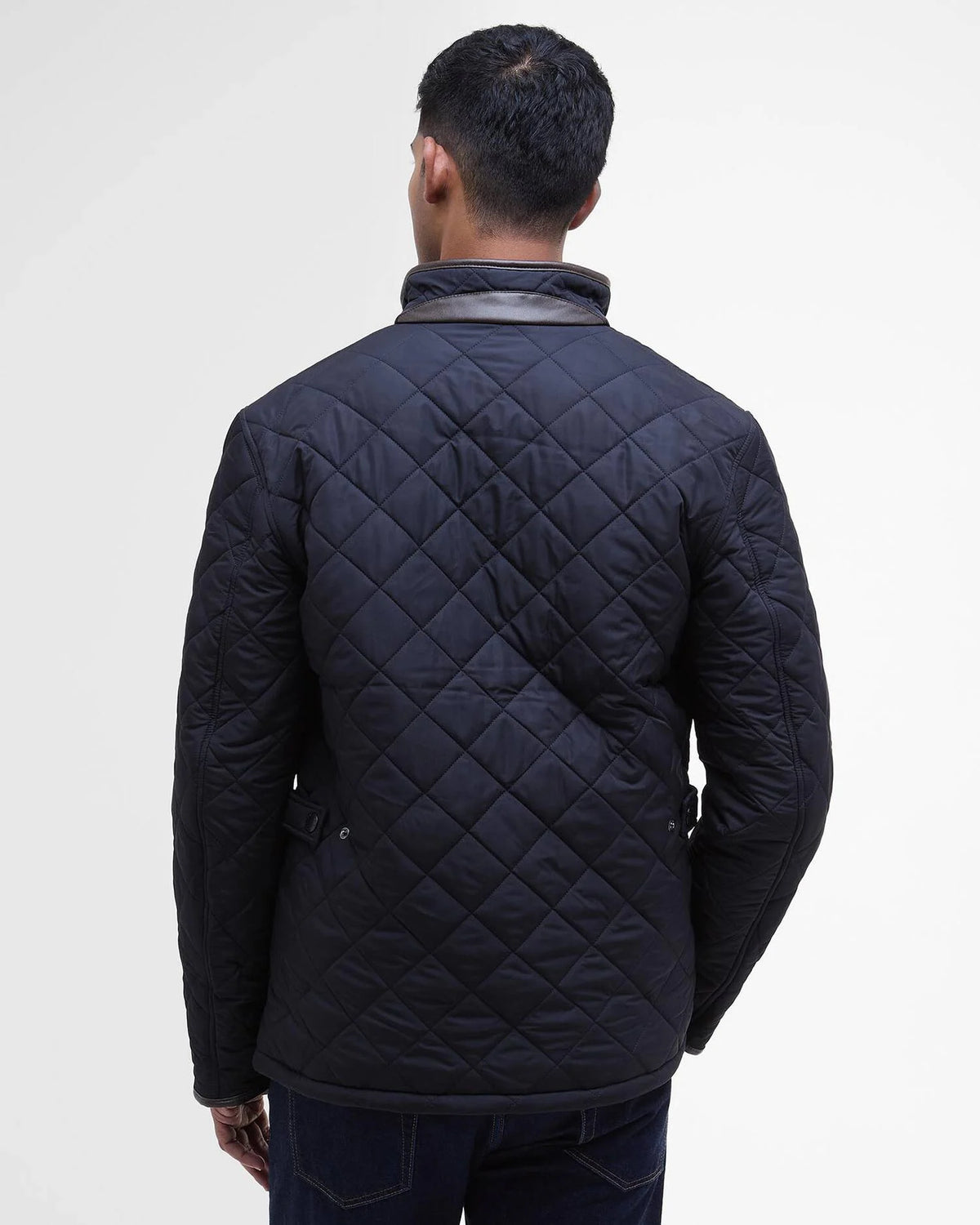 Man modeling dark colored quilted jacket