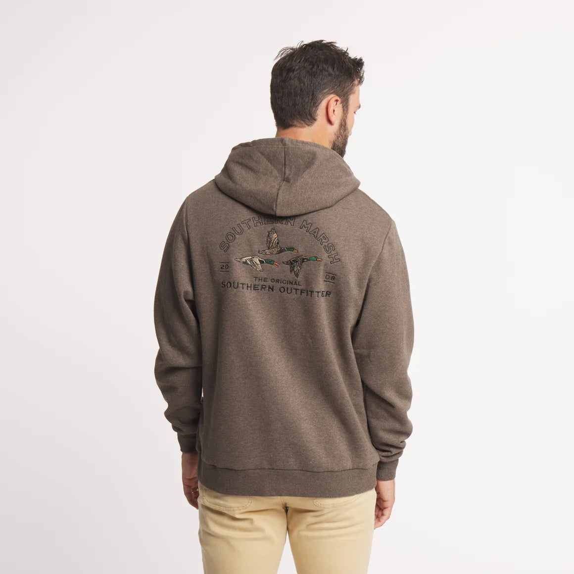 A man viewed from behind wearing a brown heathered hoodie with a graphic on the back that reads 'Southern Party' and 'The Southern Outfitter', paired with beige pants, against a plain white background.