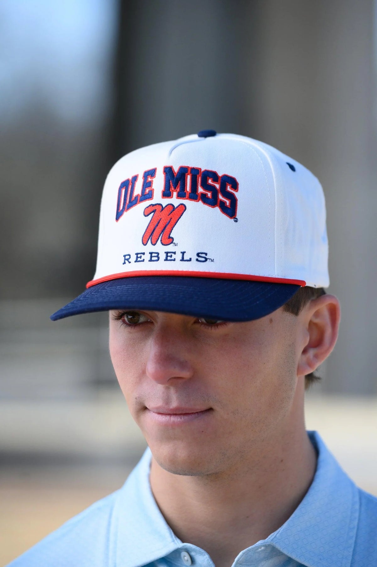 Person wearing an Ole Miss Rebels cap with a blurred background