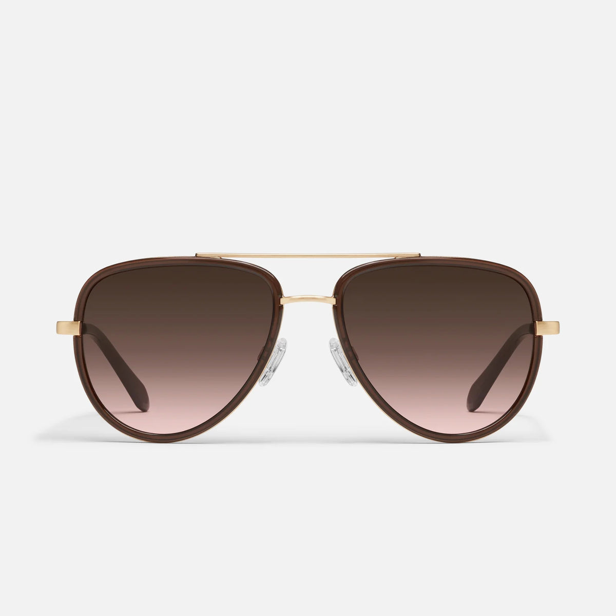 Aviator sunglasses with gold frame and brown gradient lenses on a light gray background