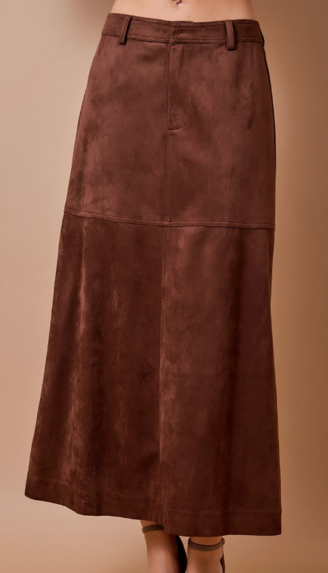 A brown suede-like midi skirt with a front zipper and belt loops, shown on a model against a solid beige background.