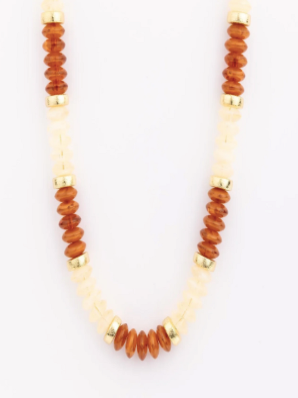 A beaded necklace featuring alternating strands of translucent amber-brown disc beads and creamy off-white chunky stone beads, separated by small gold spacer rings, shown against a plain white background.