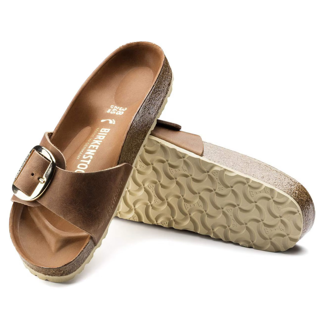 Brown sandal with a buckle on a white background