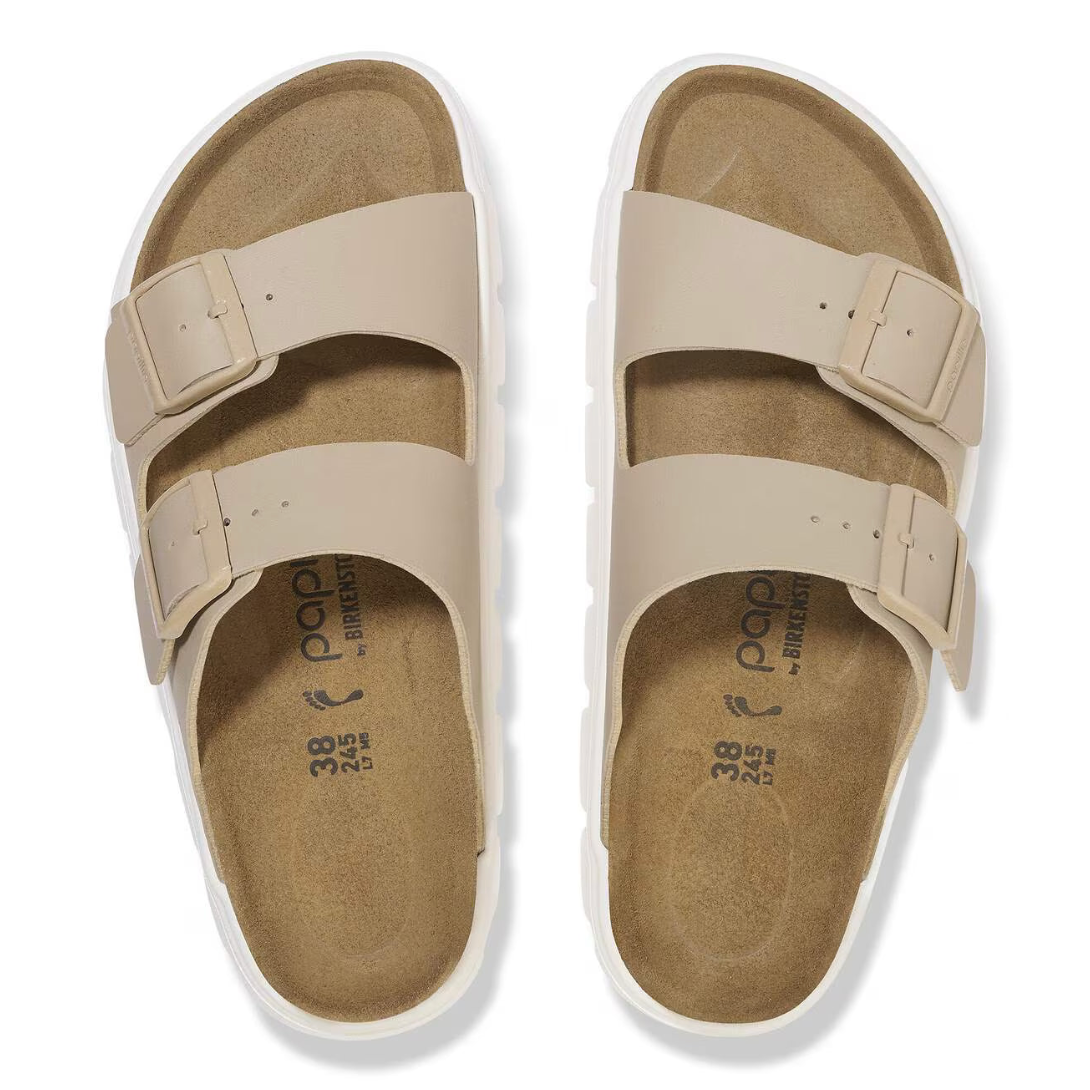 Beige sandals with white soles on a white background
