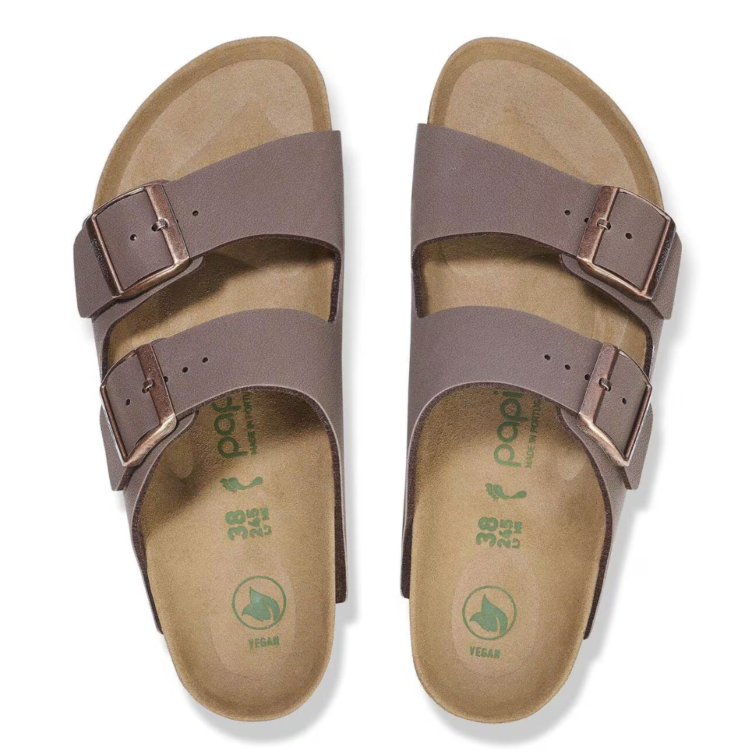 Pair of brown sandals with double straps on a white background