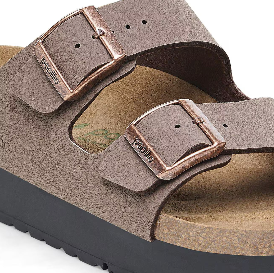 Brown sandal with a buckle on a white background