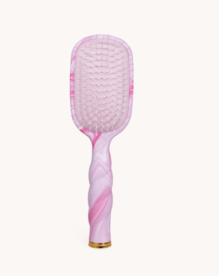Pink patterned hairbrush on a white background