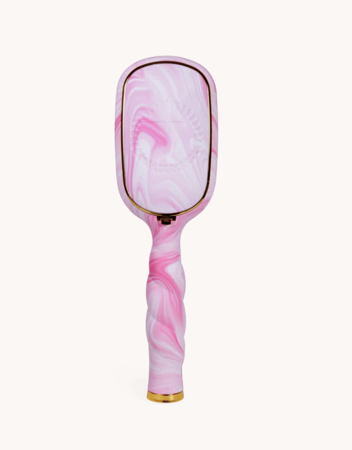 Pink and white marbled paddle brush on a white background