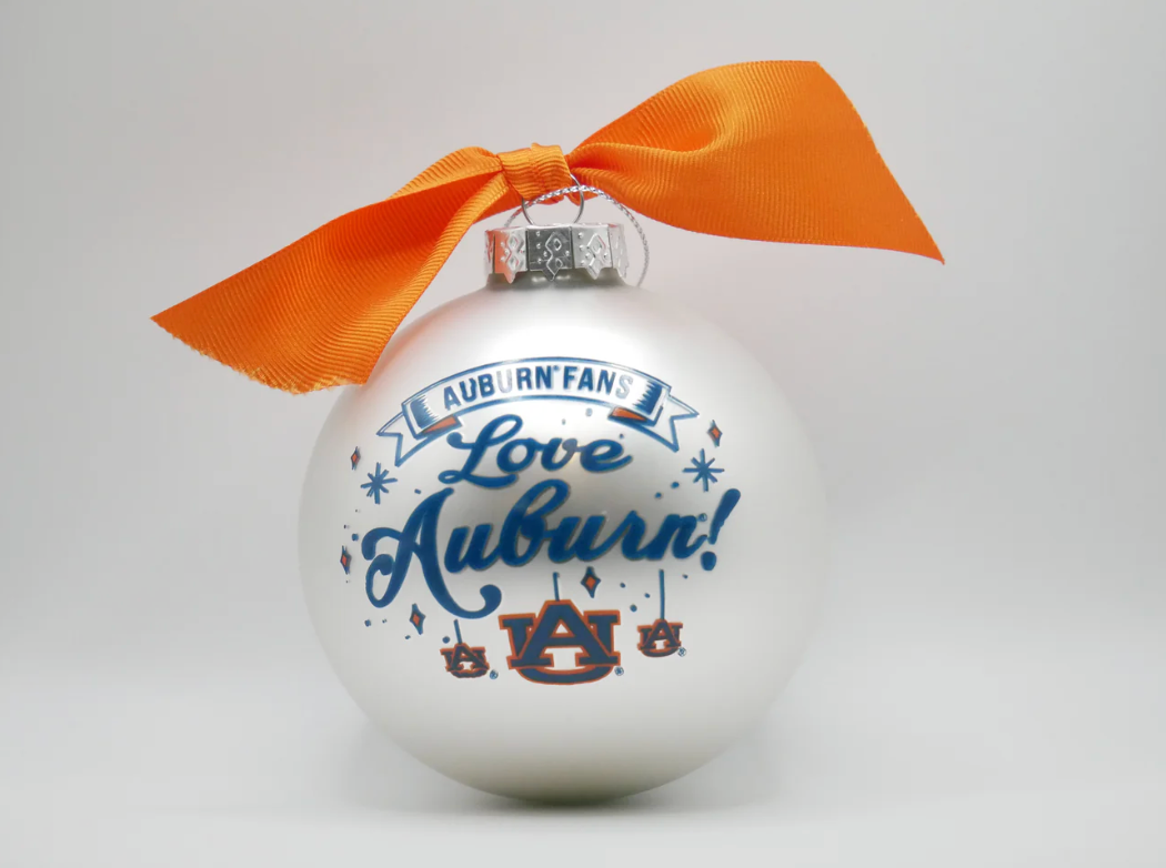 Decorative ornament with 'Auburn Fans Love Auburn!' text and orange ribbon on a white background