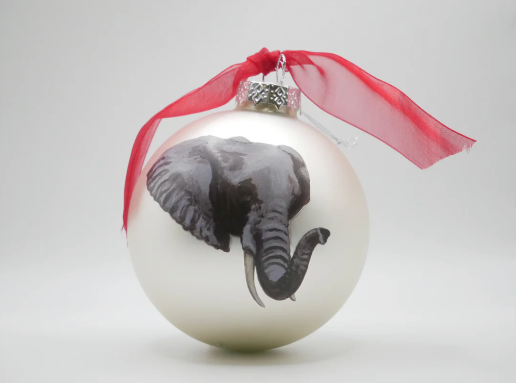 Decorative Christmas ball with an elephant design and a red ribbon on a white background