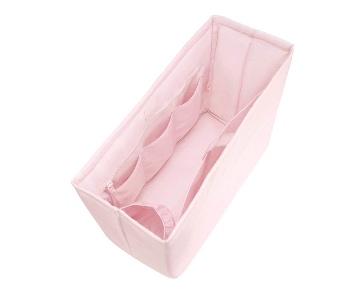 Pink baby bathtub with soft mesh sides on a white background