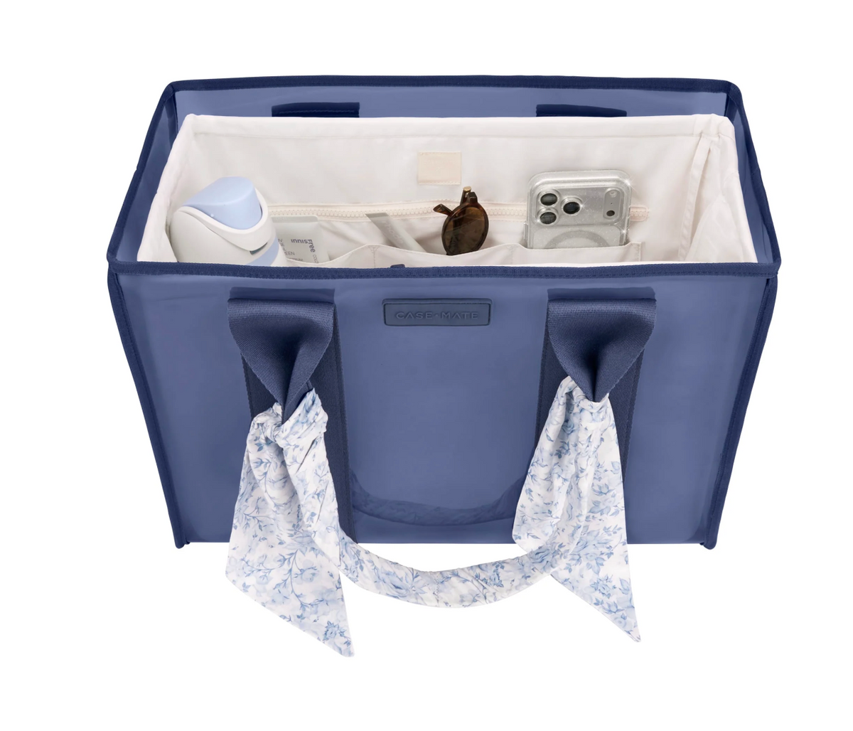 Blue organizer bag with white interior, containing items like a phone and a bottle, on a white background.
