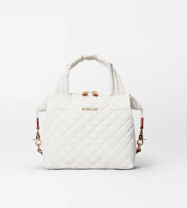 White quilted handbag with gold chain on a white background