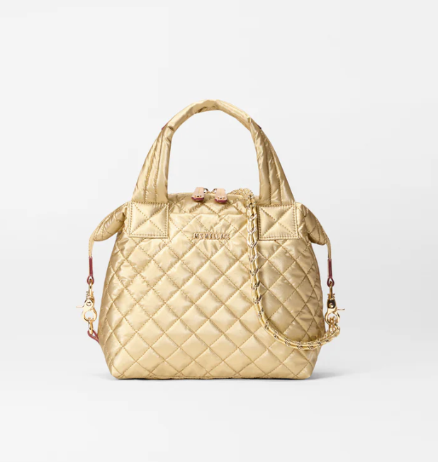 gold Quilted handbag with gold chain detail on a light gray background